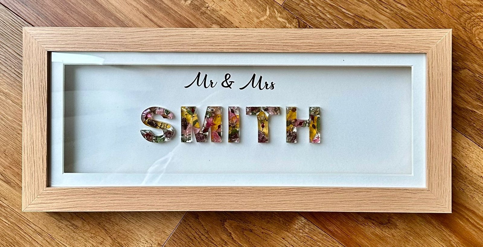 Resin flower preservation — wedding date frame close up